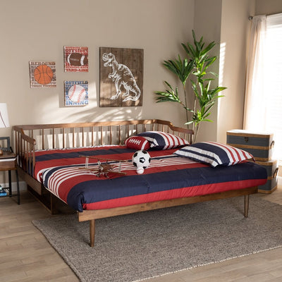 Bedroom with wooden bed, red and blue bedding, sports-themed decor, and plant.