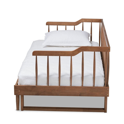 Wooden crib with white mattress and pillow on a white background