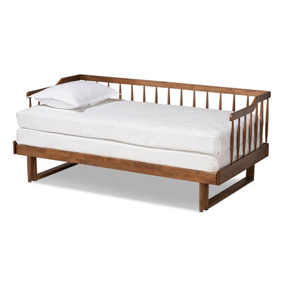 Wooden daybed with white mattress and pillow on a white background