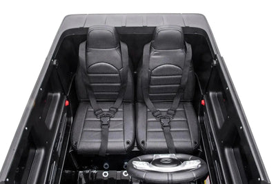 24V black Mercedes Benz G63 AMG 4x4 ride-on car for kids, featuring a realistic luxury SUV design, two seats, LED lights, working doors, and all-terrain wheels.