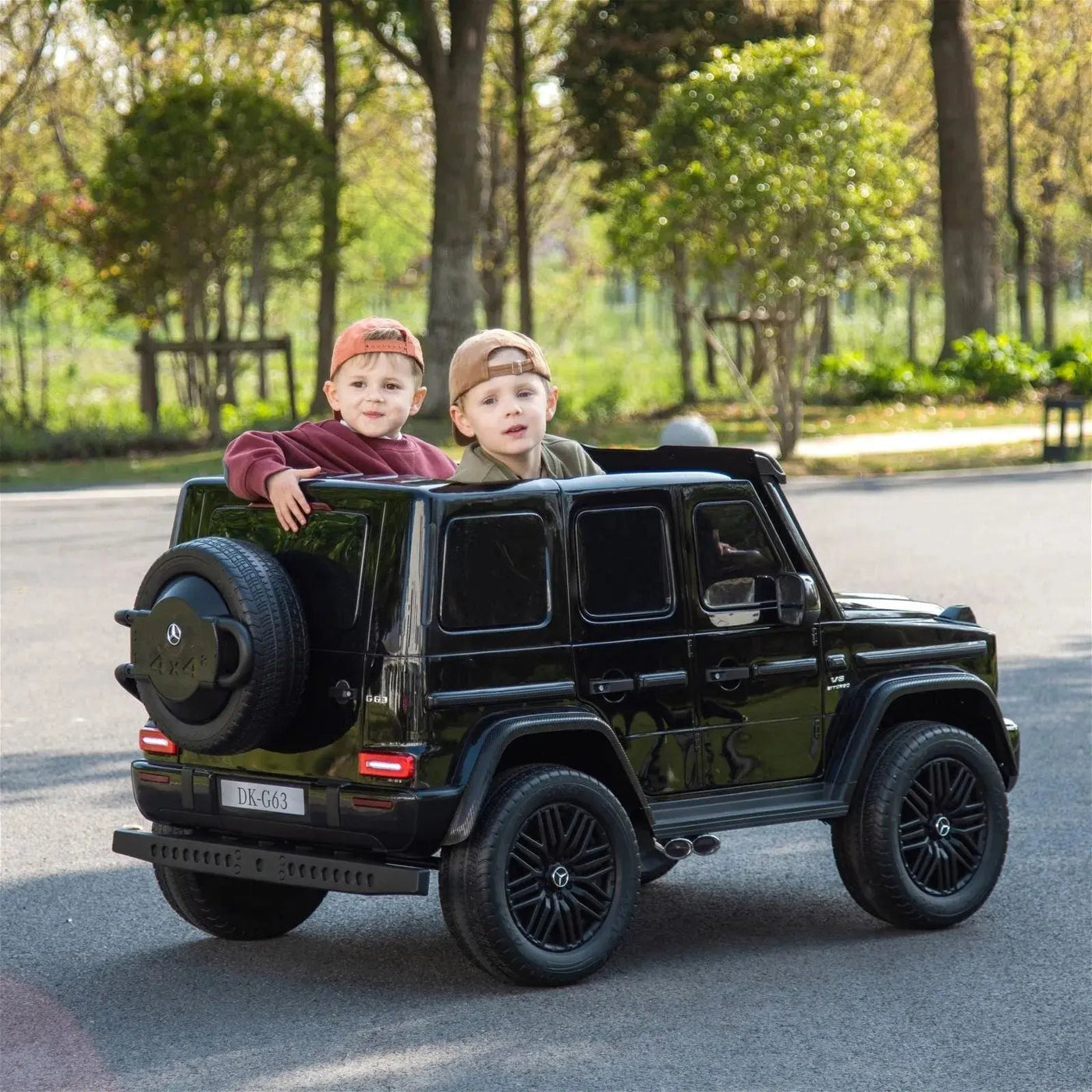 24V black Mercedes Benz G63 AMG 4x4 ride-on car for kids, featuring a realistic luxury SUV design, two seats, LED lights, working doors, and all-terrain wheels.