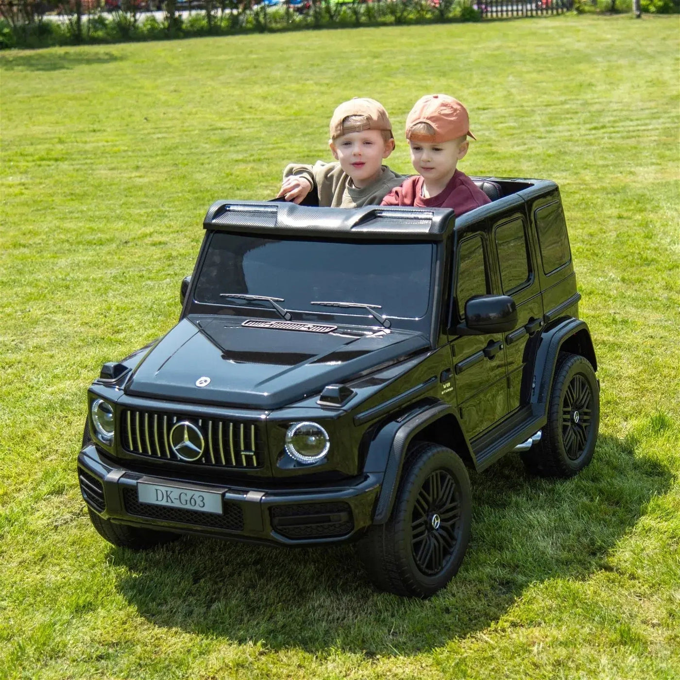 24V black Mercedes Benz G63 AMG 4x4 ride-on car for kids, featuring a realistic luxury SUV design, two seats, LED lights, working doors, and all-terrain wheels.