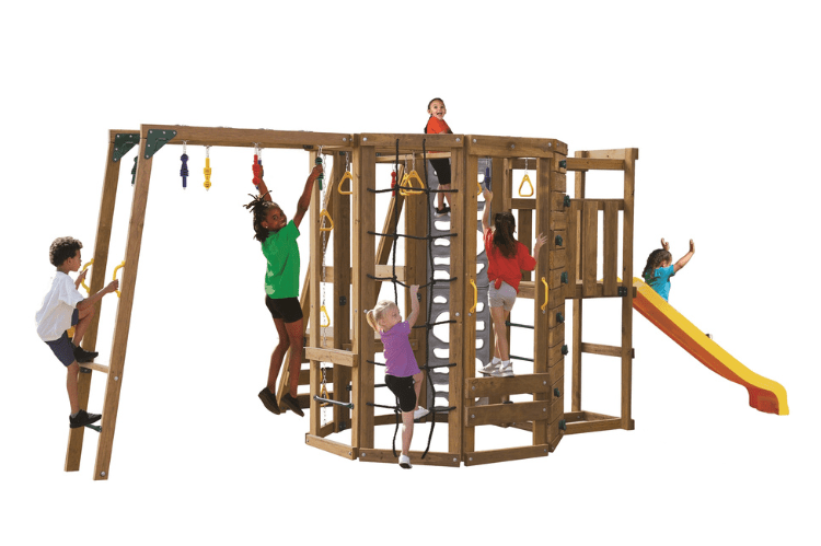 Children playing on Ninja Power Tower Bronze playground set with a slide and climbing structures.