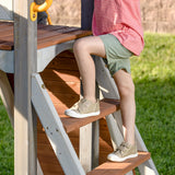 Jack & June Haven II wooden swing set with slide, rock wall, and two belt swings for backyard outdoor play