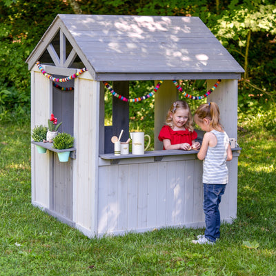 Jack & June wooden outdoor playhouse for kids with windows, door, and porch – ideal backyard play structure for imaginative play.