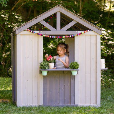 Jack & June wooden outdoor playhouse for kids with windows, door, and porch – ideal backyard play structure for imaginative play.